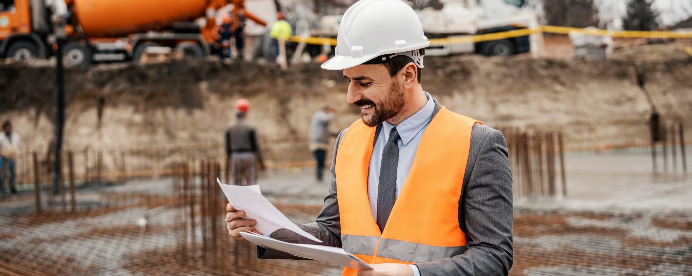 A,Happy,Contractor,Is,Looking,At,The,Documents,And,Checking